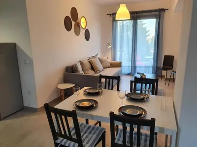 a dining room and living room with a table and chairs at Kalavarda Cosy Home 2 in Kalavárda