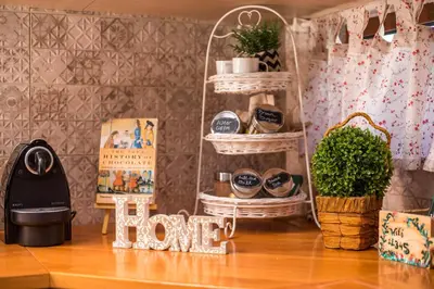 a room with baskets and plants on a wooden floor at Wine & Vineyard Retreat Emarmene in Koskinou