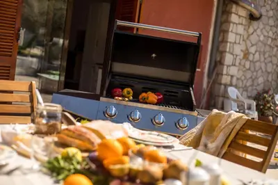 a table with a stove with food on it at Wine & Vineyard Retreat Emarmene in Koskinou