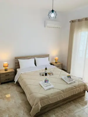 a bedroom with a large bed with two dishes on it at Escape Rooms in Afantou