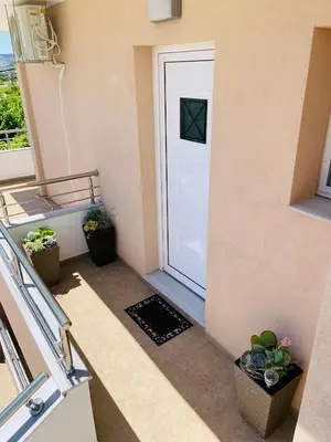 a stairway with a white door and some plants at Escape Rooms in Afantou