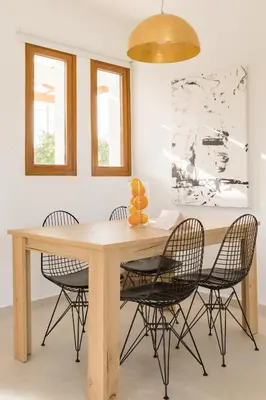 a dining room table with four chairs around it at Villa Santa Maria with private pool and sea view in Afantou
