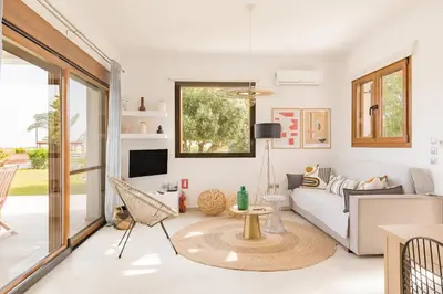 a living room with a couch and a table at Villa Santa Maria with private pool and sea view in Afantou
