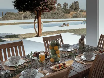 a wooden table with fruit on top of it at Villa Santa Maria with private pool and sea view in Afantou
