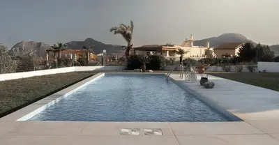a swimming pool in front of a house at Villa Santa Maria with private pool and sea view in Afantou