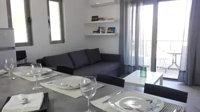 a living room with a table and a couch at Kalavarda Cosy Home 1 in Kalavárda