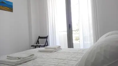 a white bedroom with a bed with towels on it at Kalavarda Cosy Home 1 in Kalavárda