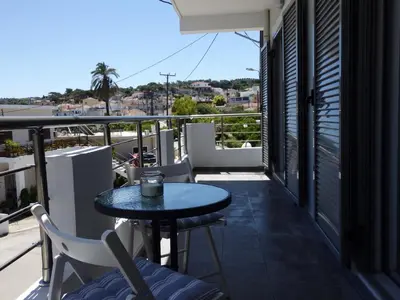 a patio with a table and chairs on a balcony at Kalavarda Cosy Home 1 in Kalavárda