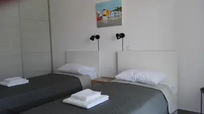 two beds sitting next to each other in a room at Kalavarda Cosy Home 1 in Kalavárda