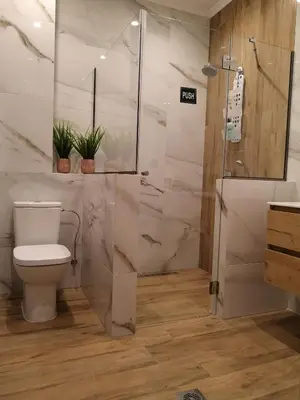 a bathroom with a toilet and a shower at SUNNY HOLIDAYS APARTMENT in Kremasti