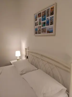 a bedroom with two beds and a picture on the wall at SUNNY HOLIDAYS APARTMENT in Kremasti