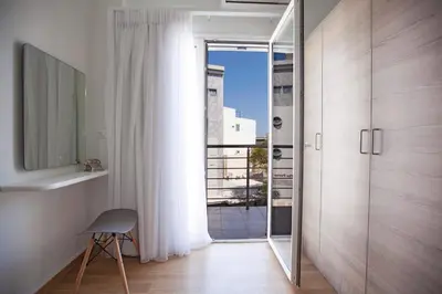 a room with a glass door leading to a balcony at Aegean Living in Rhodes Town