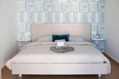 a bedroom with a bed with a sign on it at Aegean Living in Rhodes Town