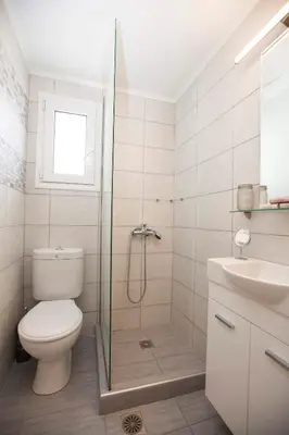 a bathroom with a shower and a toilet and a sink at Aegean Living in Rhodes Town