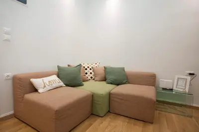 a living room with a couch and two chairs at Aegean Living in Rhodes Town