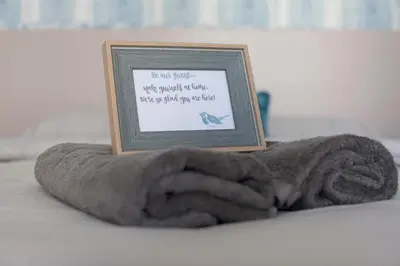 a picture in a frame on top of a towel at Aegean Living in Rhodes Town