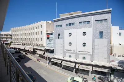 a city street with a large building with a parking lot at Aegean Living in Rhodes Town