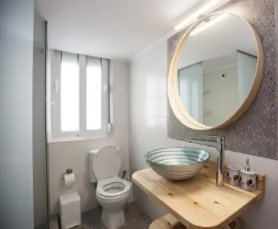 a bathroom with a bowl sink and a mirror at Great Living in Rhodes Town