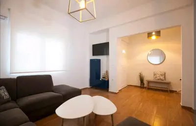 a living room with a couch and a table at Great Living in Rhodes Town