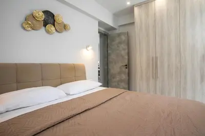 a bedroom with a bed with hats on the wall at Casa Antonis - Modern Home with Jacuzzi near Faliraki in Kalithies