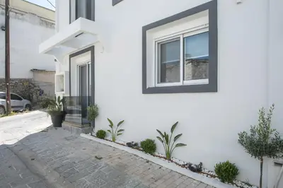 a white house with a window and plants at Casa Antonis - Modern Home with Jacuzzi near Faliraki in Kalithies