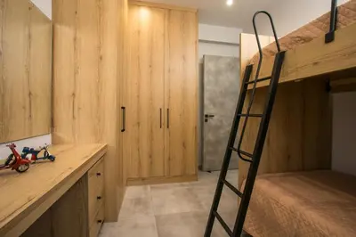 a bedroom with a bunk bed and a ladder at Casa Antonis - Modern Home with Jacuzzi near Faliraki in Kalithies