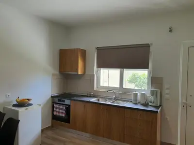 a kitchen with a sink and a window at Perama View Apartments in Eleoúsa