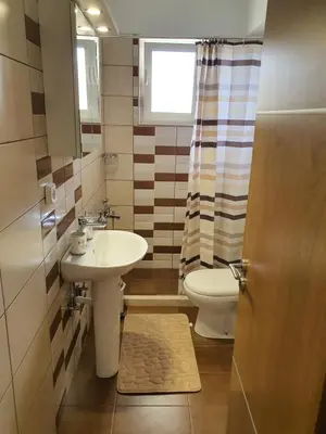 a bathroom with a sink and a toilet at Perama View Apartments in Eleoúsa
