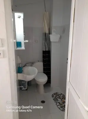 a small bathroom with a toilet and a sink at Jaana & Akis Holiday Home 1&2, Haraki in Haraki