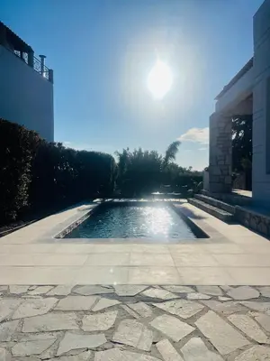 a swimming pool in the middle of a patio at Seaview Villa - Amazing Sea & Mountain View in Koskinou