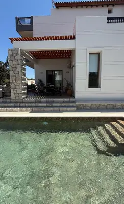 a house with a swimming pool in front of it at Seaview Villa - Amazing Sea & Mountain View in Koskinou