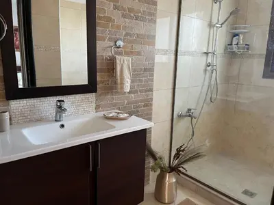 a bathroom with a sink and a shower at Seaview Villa - Amazing Sea & Mountain View in Koskinou