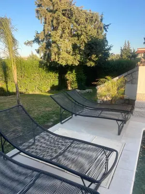 two metal benches sitting on a patio at Seaview Villa - Amazing Sea & Mountain View in Koskinou