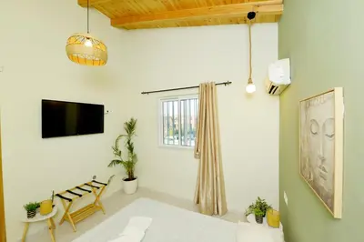a living room with a tv and a couch at Jimmy's Pool House in Kremasti