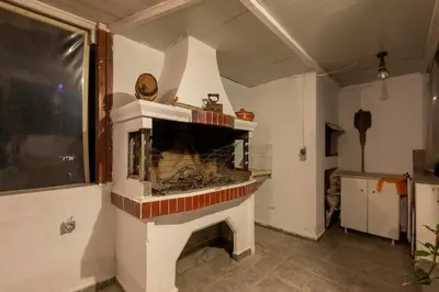 a living room with a fireplace in a room at Jimmy's Pool House in Kremasti