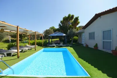 a swimming pool in the yard of a house at Jimmy's Pool House in Kremasti