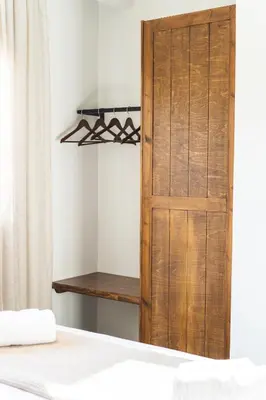 a wooden door in a room with a bed at Aesthisis Sensational Accommodation in Kolimbia