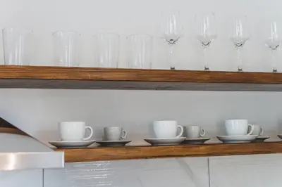 a row of glasses and cups on a shelf at Aesthisis Sensational Accommodation in Kolimbia