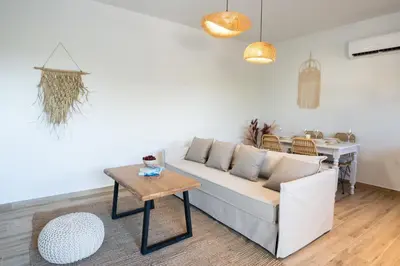 a living room with a couch and a table at Aesthisis Sensational Accommodation in Kolimbia