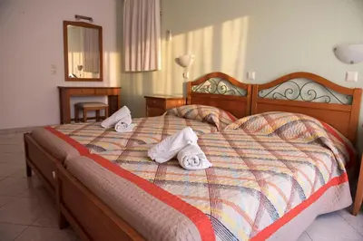 a bedroom with a bed with towels on it at Nephele Apartments in Faliraki
