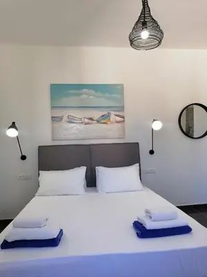 a bedroom with a bed with two towels on it at Villa Mare by Delfinia Resort in Kolimbia