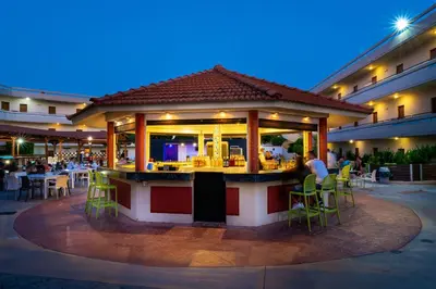 a restaurant with a bar in the middle of a building at Villa Mare by Delfinia Resort in Kolimbia