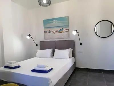 a bedroom with a bed with two towels on it at Villa Mare by Delfinia Resort in Kolimbia
