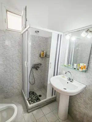 a bathroom with a shower and a sink at Daisy's room in Archangelos