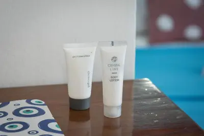 two bottles of cream like products sitting on a table at Daisy's room in Archangelos
