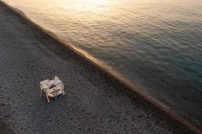 an object sitting on the beach next to the water at Aethrion Villas & Suites in Gennadi