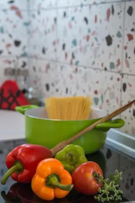 a plate of vegetables on a counter with a bowl of pasta at Villa Bella Montagna in Kapíon
