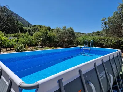 a swimming pool on the deck of a villa at Villa Bella Montagna in Kapíon