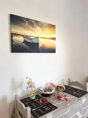 a table with a picture of a boat in the water at Gennadi Sun Apartments 500m from the beach in Gennadi