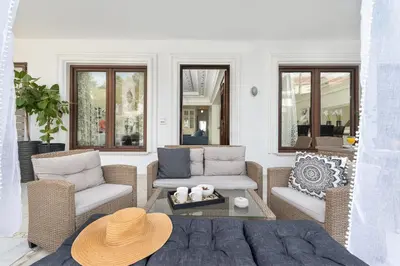a living room with two chairs and a couch at Mikaela's Pool House in Afantou